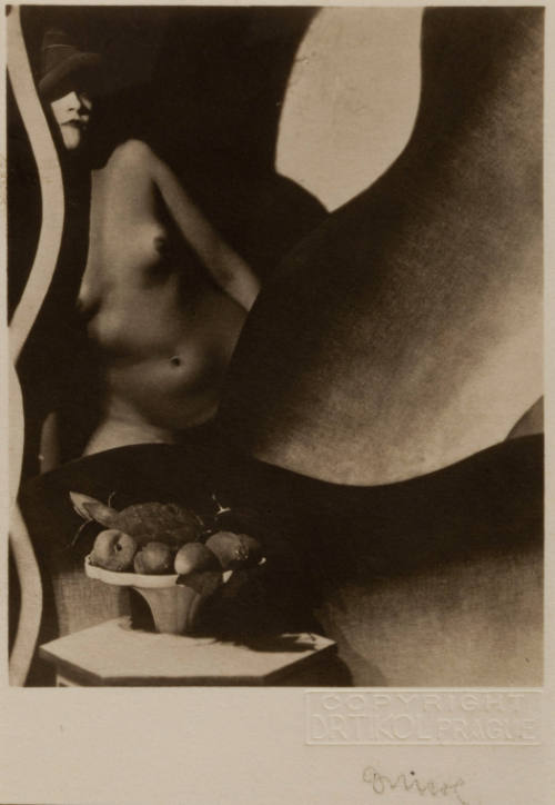 Untitled [Nude with Hat and Bowl of Artificial Fruits, Posed Amongst Undulating Stage Props]