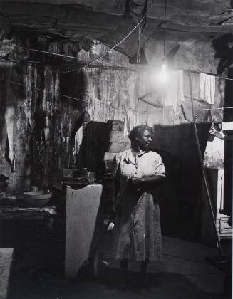 Untitled (Chicago Housing Authority: Women Sweeping Floor, Dimly Lit Home)