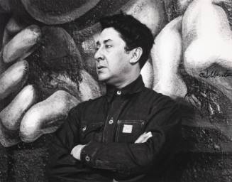 David Alfaro Siqueiros (in front of his mural in a club in Mexico City)