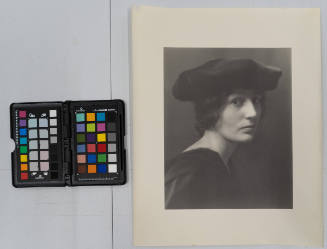 Portrait of a woman in black hat, slouched, ? view of face and shoulders