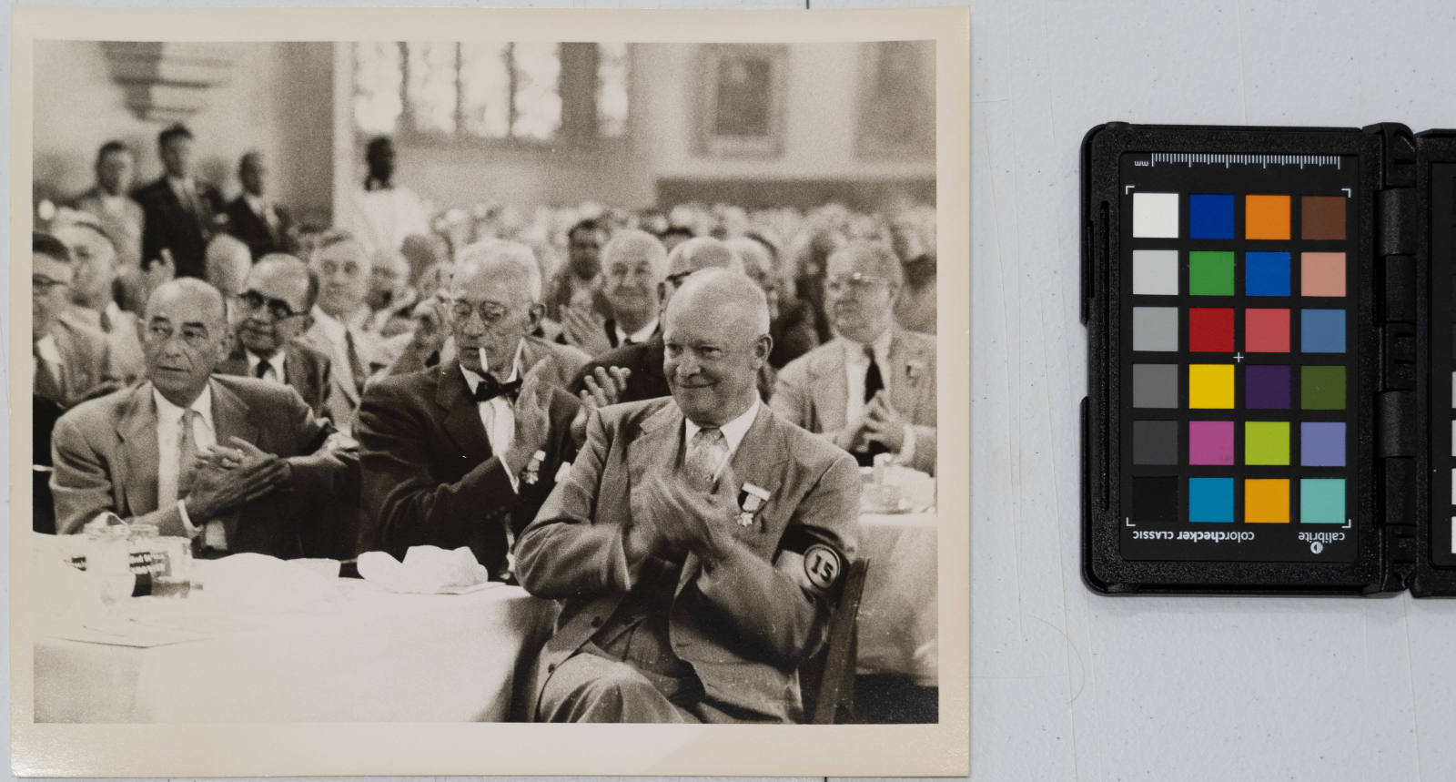 Dwight Eisenhower clapping at West Point graduation banquet