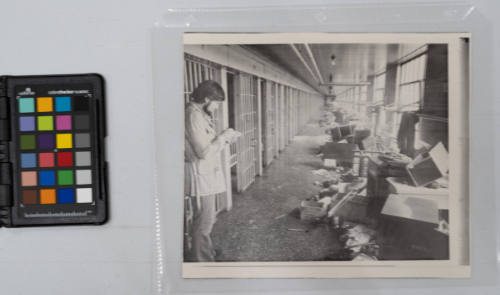 Cellblock at Besieged Prison: A newsman takes notes on the view of the interior of Attica State Prison cellblock where rebellious prisoners held 38 hostages for five days. A representative of the prison said some of the bodies of the hostages were found here, September 14, 1971