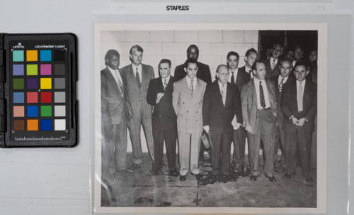 Shown after their conviction in U.S. District Court here today are the 11 Communist leaders charged with conspiracy to teach and advocate the forcible overthrow of the government. Left to right are: Henry Winston, Eugene Dennis, Jacob Stachel, Gilbert Green, Benjamin Davis, John Williamson, Robert G. Thompson, Gus Hall, Irving Potash, Carl Winter, John Gates. Men at upper right behind the two lines of prisoners are unidentified court attaches, New York City