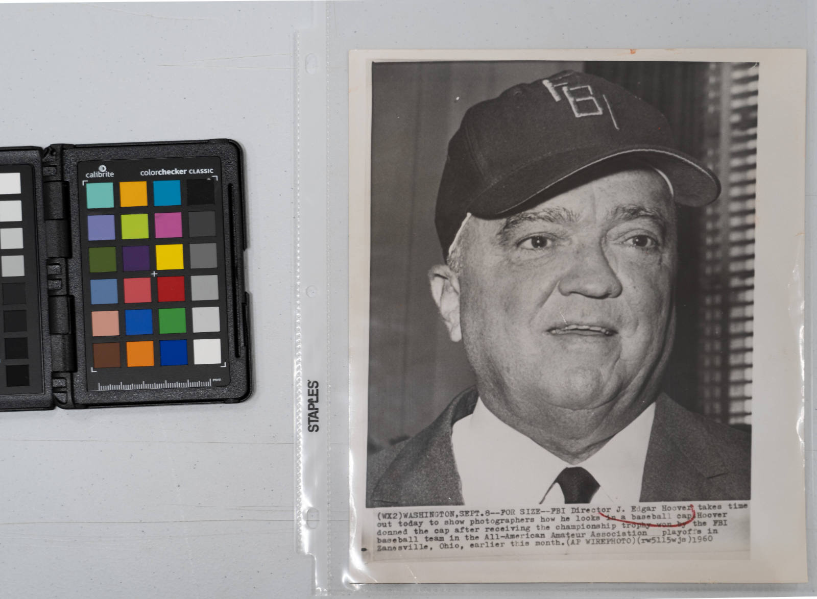 For Size: FBI Director J. Edgar Hoover takes time out today to show photographers how he looks in a baseball cap. Hoover donned the cap after receiving the championship trophy won by the FBI baseball team in the All-American Amateur Association playoffs in Zanesville, Ohio, earlier this month, Washington D.C., September 8, 1960