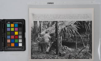 Thatched Hut of the Viet Cong Type in Cambodia: Cambodian military officials and a newsman inspect a thatched hut in Cambodia just a short distance from the South Vietnamese border. The hut was one of the structures discovered in what was believed to be a Vietcong campsite in Cambodia, November 18, 1967