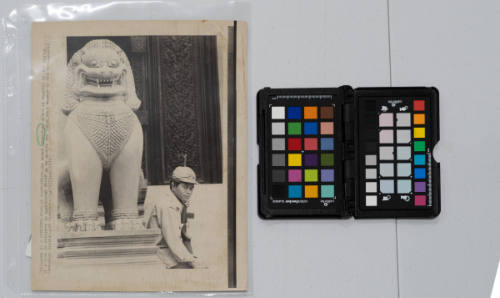 A Concrete Form Of Protection: an armed Cambodian guard is dwarfed by the statue of a lion in concrete in traditional design as he guards the Phnom Penh museum in the beleaguered Cambodian capital on May 24, 1973