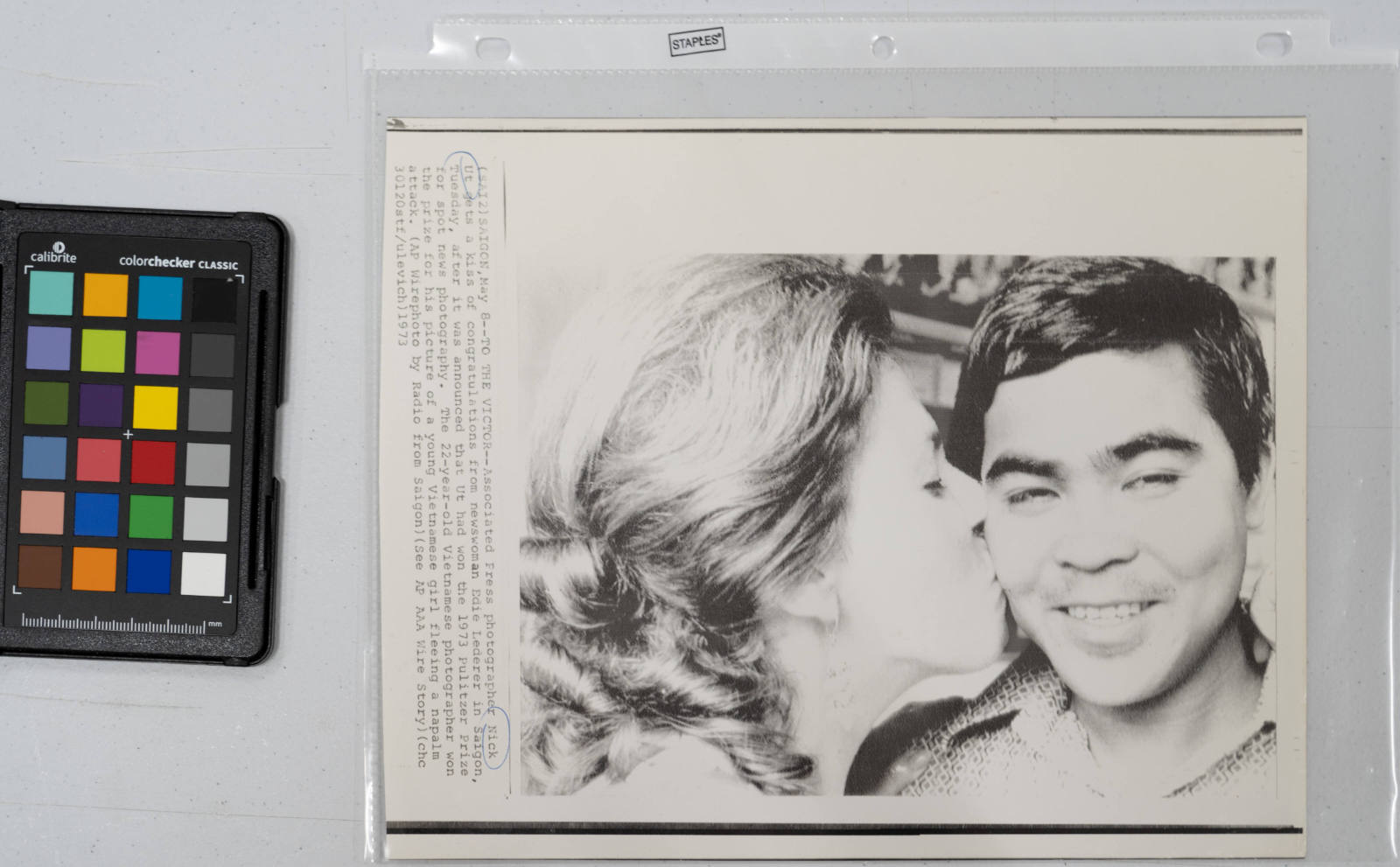 To The Victor: Associated Press Photographer Nick Ut gets a kiss of congratulations from newswoman Edie Lederer in Saigon, May 8, 1973, after it was announced that Ut had won the 1973 Pulitzer Prize for spot news photography. The 22-year-old Vietnamese photographer won the prize for his picture of a young Vietnamese girl fleeing a napalm attack