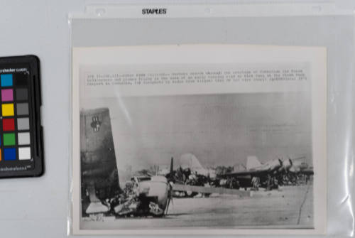 Phnom Penh Wreckage: Workers search through the wreckage of Cambodian air force helicopters and planes in the wake of an early morning raid by Vietcong on the Phnom Penh airport in Cambodia, January 22, 1971