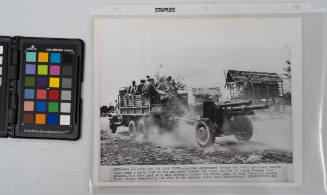 Bound For The Laos Front: Laotian government troops and their artillery weapons speed over a dusty road on the way north toward the royal capital of Luang Prabang. They were part of a mass movement toward the front lines to face Communist-backed rebel troops threatening the area in the current civil war, January 1961