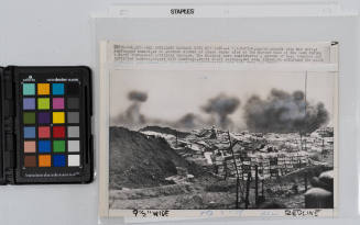 A U.S. marine, center, stands atop his post, a sandbagged bunker, as he watches clouds of black smoke rise at the marine base at Khe Sanh, South Vietnam, during a North Vietnamese artillery barrage. The marines have constructed a system of deep trenches and fortified bunkers, topped with sandbags, empty shell casings, and even timber, to withstand the daily bombardment, February 1968