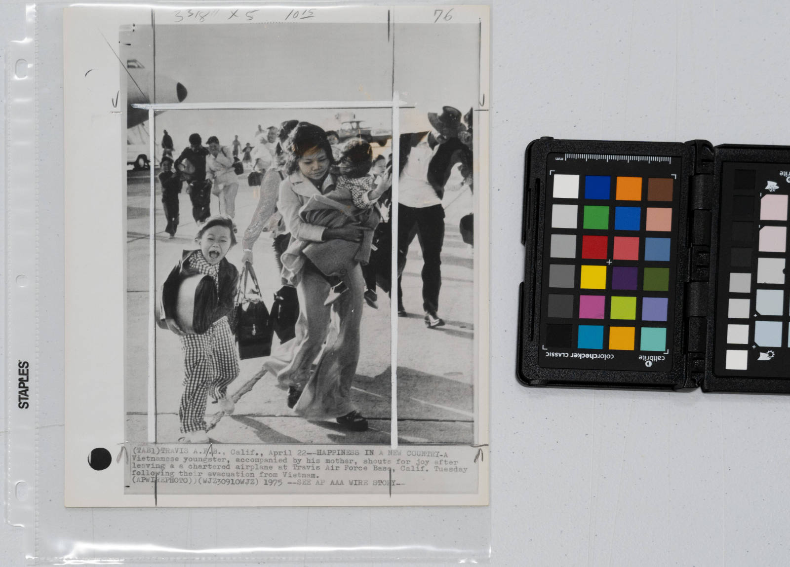 Happiness in a New Country: A Vietnamese youngster, accompanied by his mother, shouts for joy after leaving a chartered airplane at Travis Air Force Base, California, following their evacuation from Vietnam, April 22, 1975