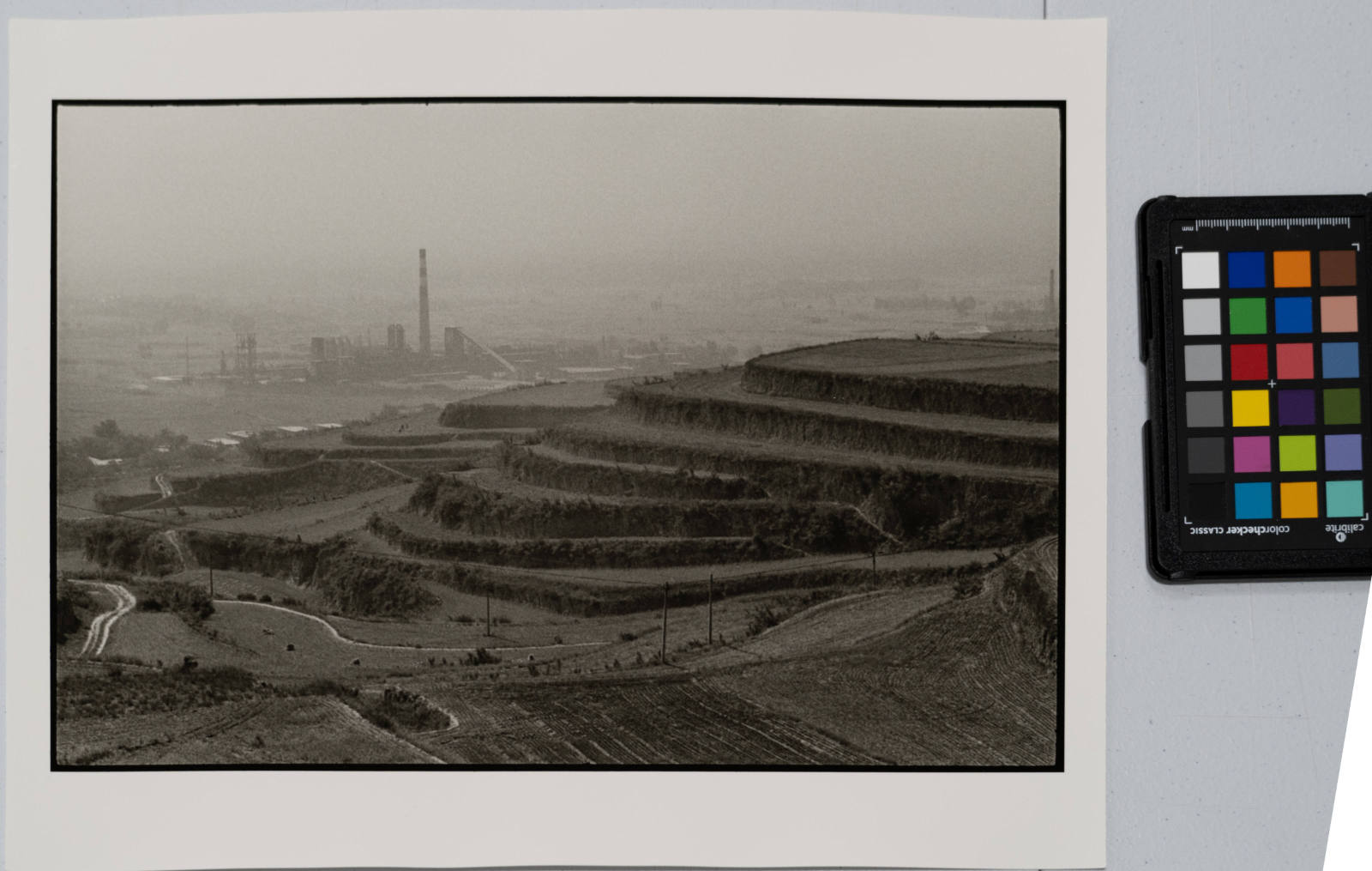 Terraced farm land with power plant, China